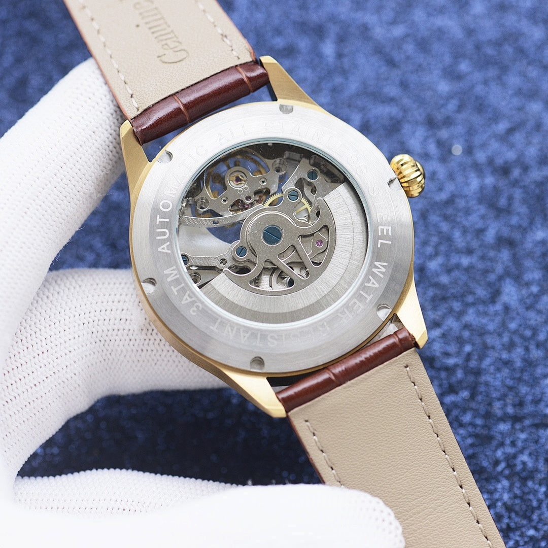 Longines watch case with exposed skeleton movement, brown leather strap, gold-tone bezel