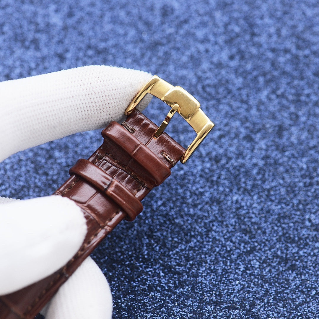Longines watch with brown leather strap and gold-tone buckle on a wristwatch case