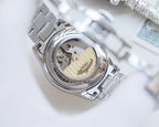 Longines watch back with see-through case showing mechanical movement
