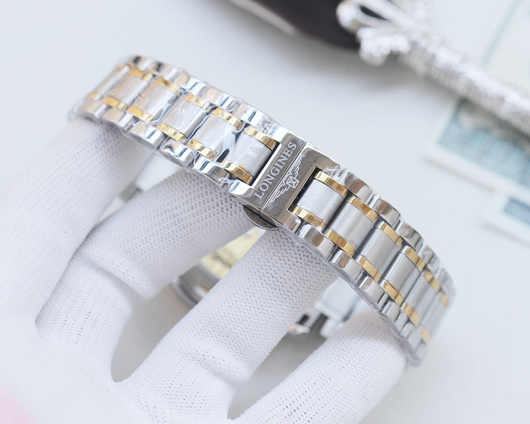 Longines bracelet links in silver and gold-tone, close-up on clasp