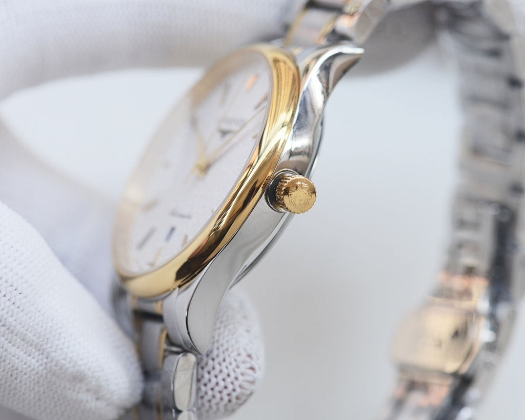 Longines watch case profile with gold-toned crown and silver bracelet links