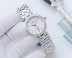 Longines watch with silver-toned case, sparkling bezel, and metal link bracelet, white dial