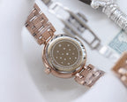 Longines watch with rose-gold case and metal bracelet, star-patterned case back visible