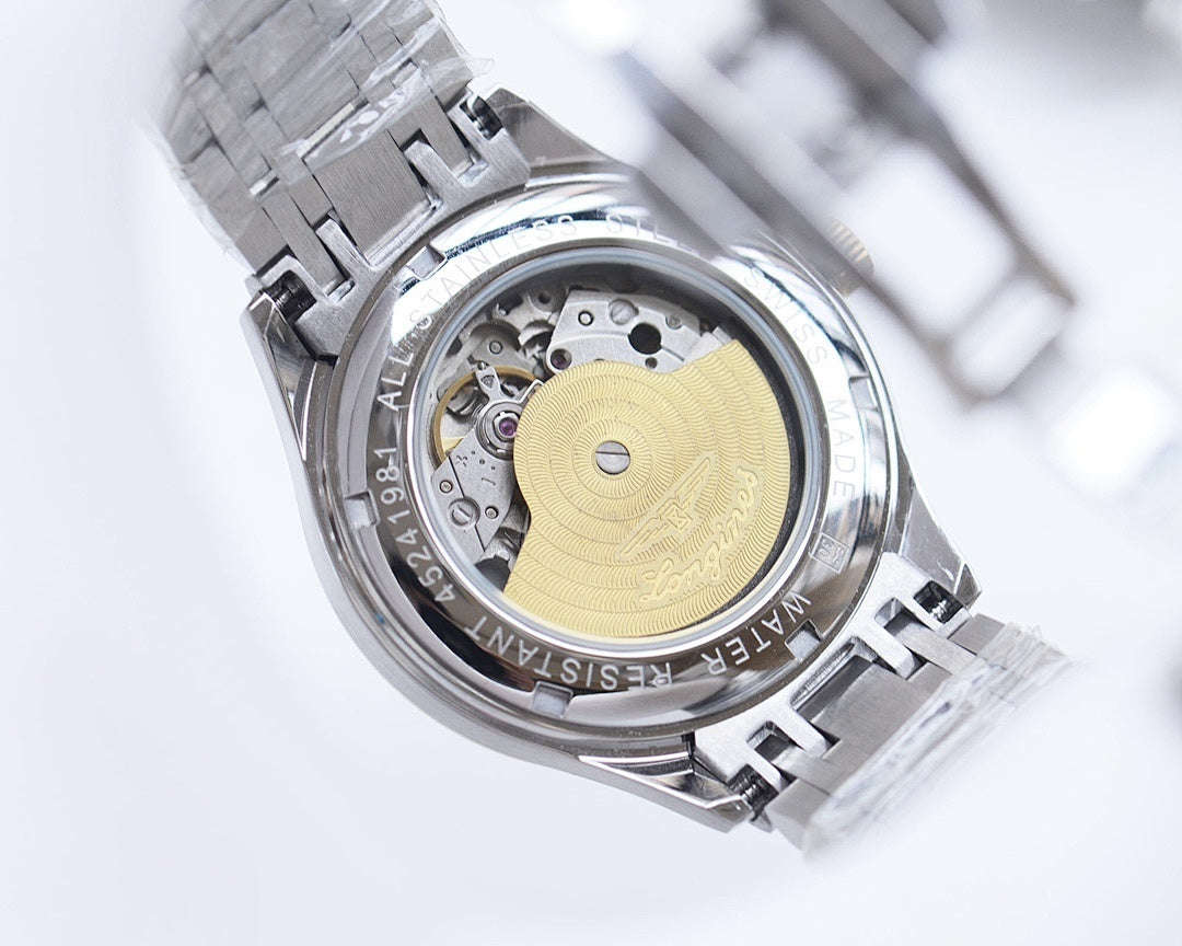 Longines watch caseback with visible movement and engraved metal rotor.
