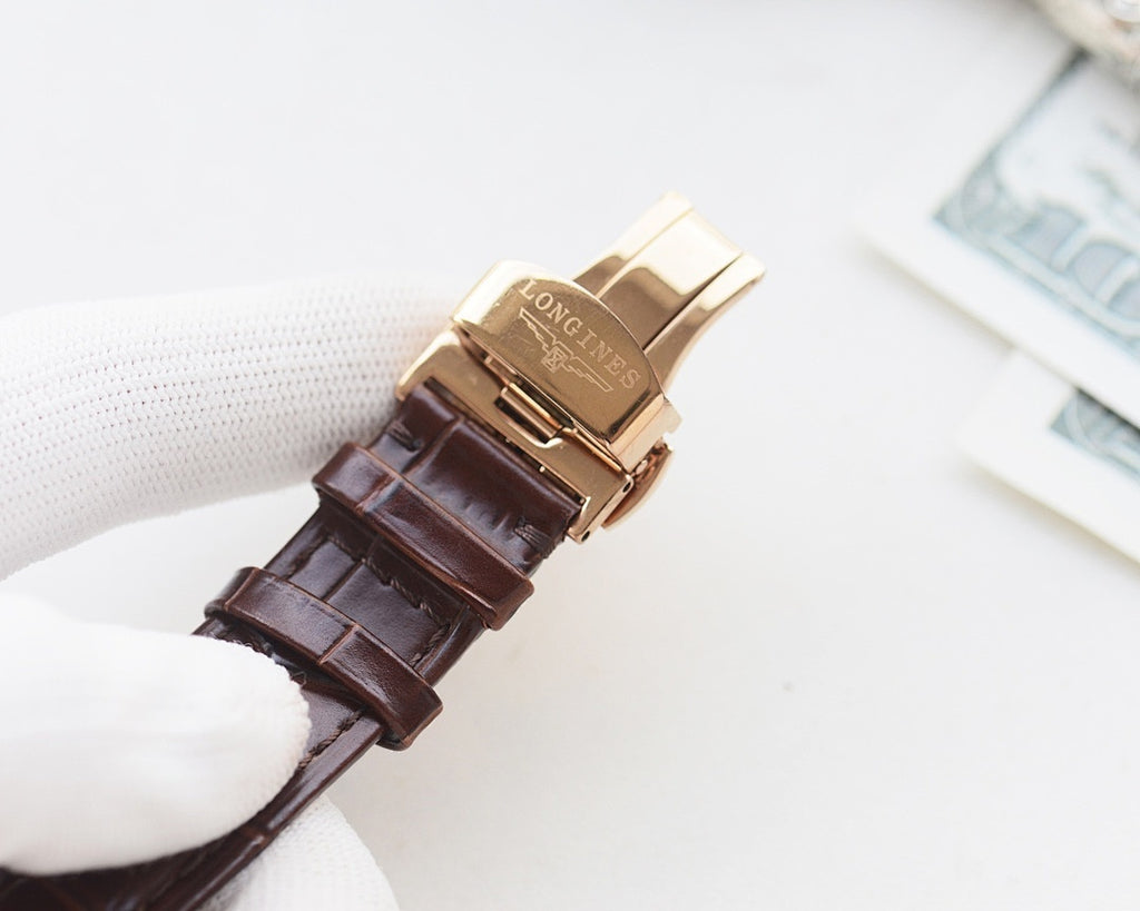Gold-tone watch case with brown leather strap and metal clasp