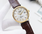 Round watch with gold-tone case, white dial, and brown leather strap