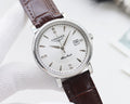 Round watch with silver case, white dial, and brown leather strap