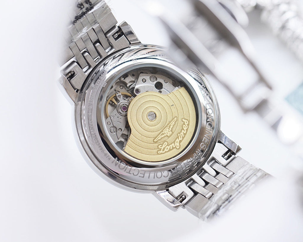 Longines automatic watch, open back showing gold dial and metal movement