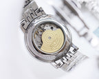 Longines automatic watch, open back showing gold dial and metal movement