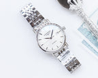 Longines automatic watch with white dial and silver bracelet, angled view