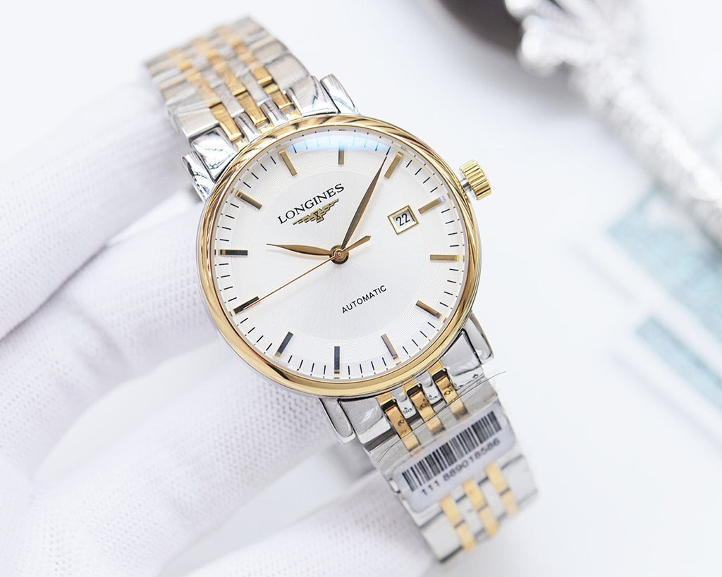 Longines automatic watch with white dial and gold-tone accents, wrist view