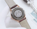 Longines watch caseback with logo, brown leather strap, dark dial center, round case