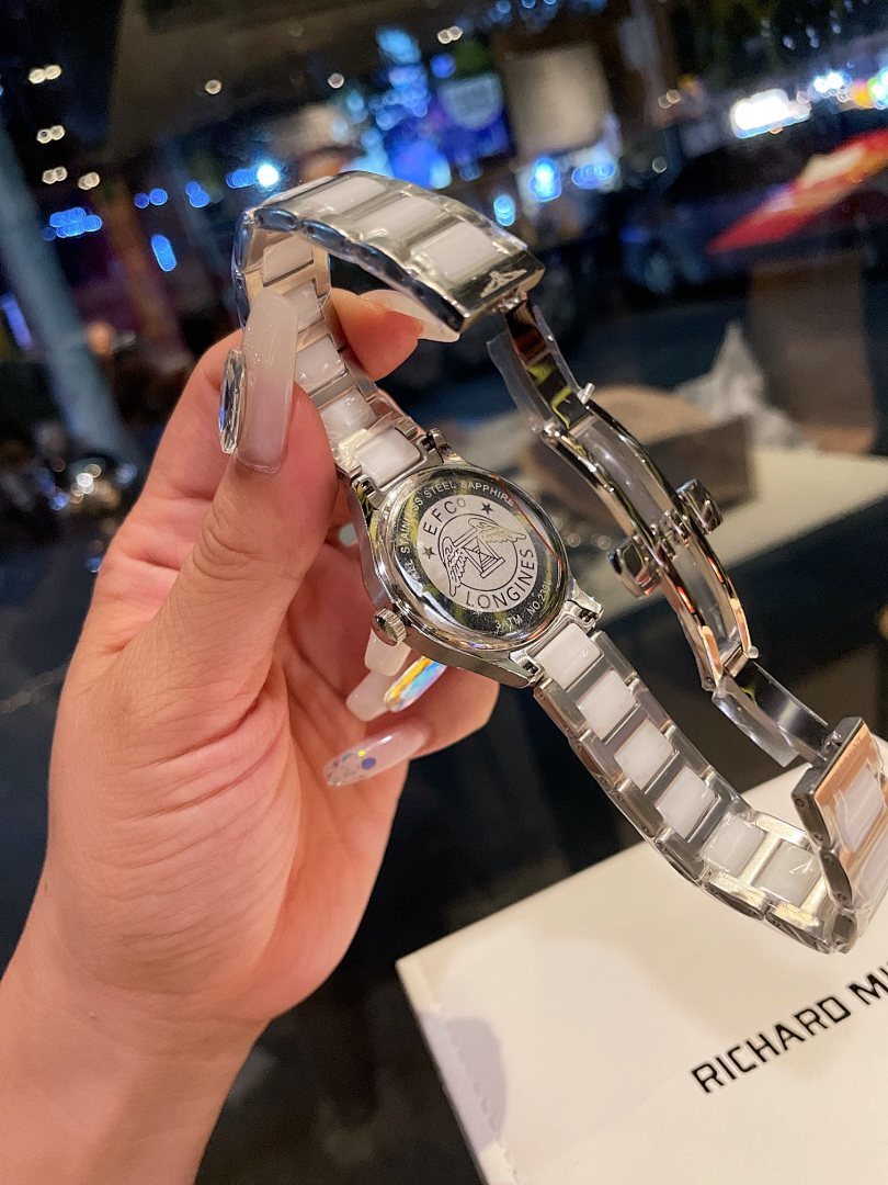 Longines stainless steel watch with silver bracelet and white dial, side profile