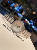 Longines stainless steel watch with silver bracelet and light dial, diagonal angle
