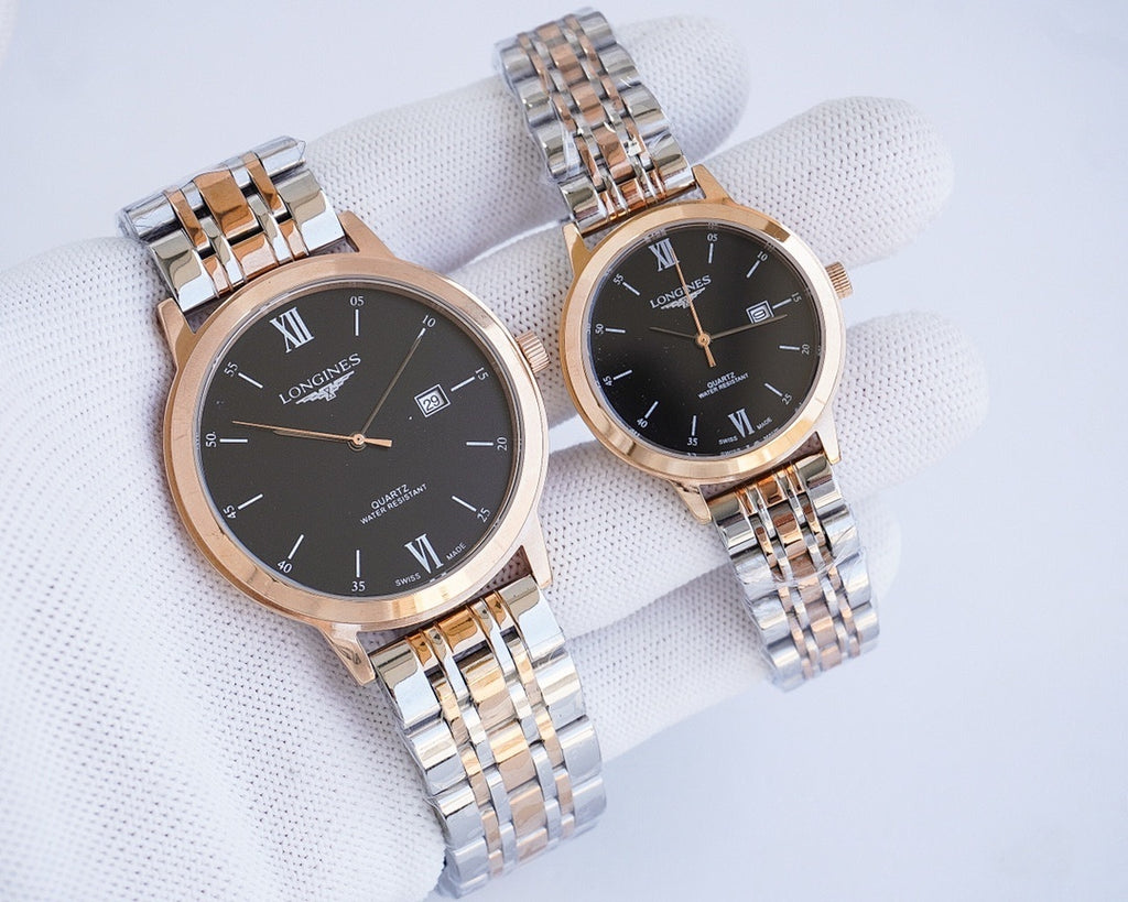 Two-tone wristwatch pair with dark dials, Roman numerals, and metal link bracelets