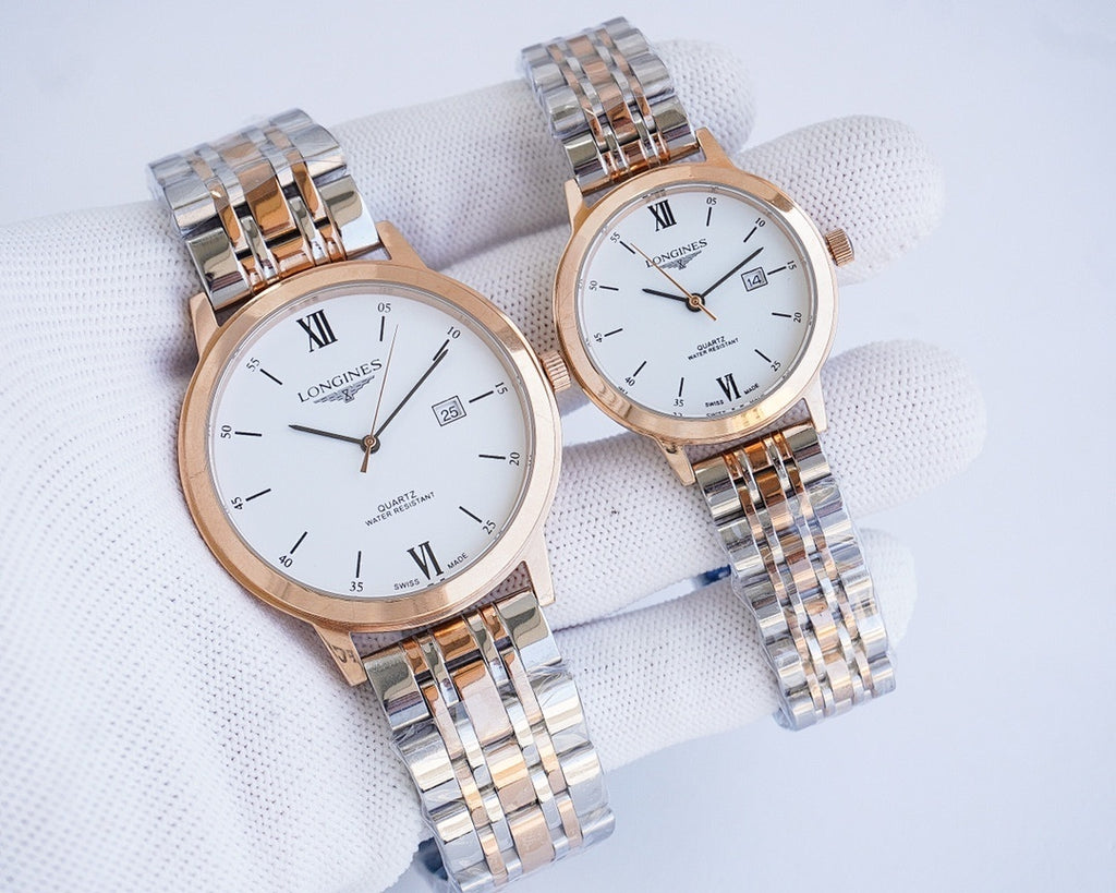Two-tone wristwatch pair with white dials and Roman numerals on metal link bracelets