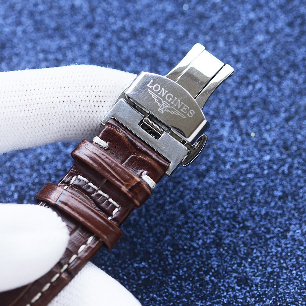 Longines watch with engraved steel clasp and brown leather strap, strap buckle detail.