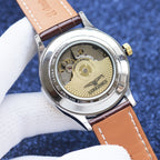 Longines watch caseback with stainless steel rear, visible movement, brown leather strap.