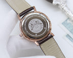 Longines watch caseback with rose-gold finish and engraved medallion, beige leather strap