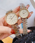 Round Longines quartz watch with gold-tone bezel and silver link bracelet, light dial