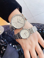 Longines quartz watch with silver link bracelet and white dial, round case
