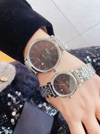 Longines quartz watch with silver link bracelet and dark brown dial, round case
