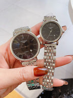Two Longines quartz watches with round cases, silver link bracelets, dark dials