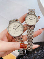 Longines quartz watches with white dials and silver link bracelets, round rose-gold cases