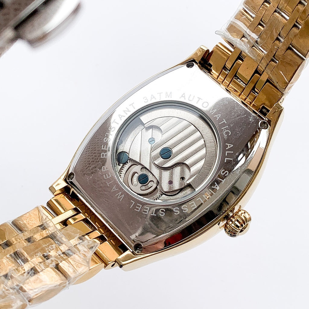 Longines watch with gold-tone bracelet and silver skeleton dial, blue accents on face.