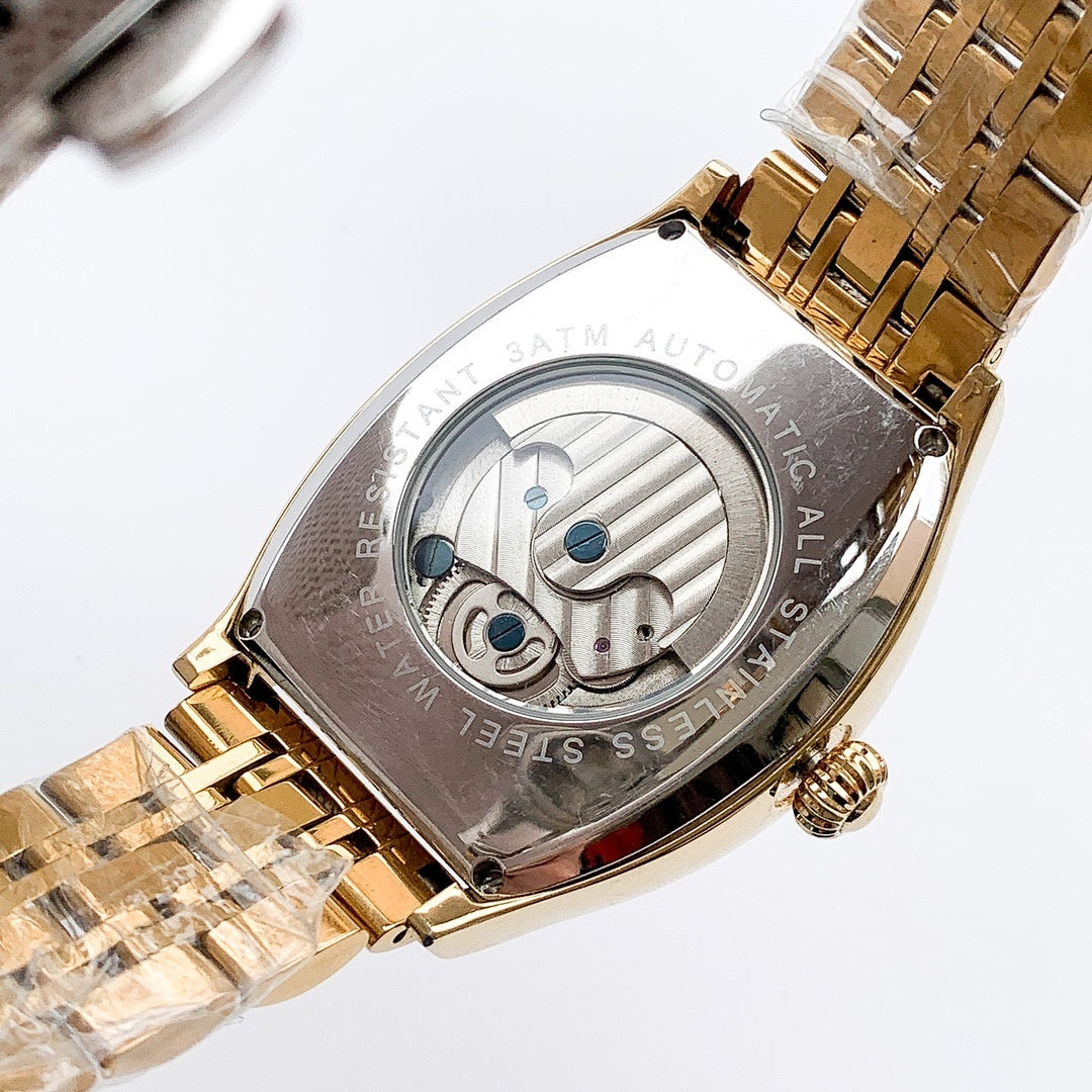 Longines watch with gold-tone bracelet and silver skeleton dial, blue accents on face.