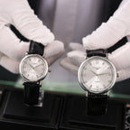 Longines quartz wristwatch with white dial and black leather strap, Roman numerals