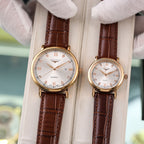 Longines quartz wristwatch with gold-tone case, white dial, and brown leather strap