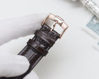 Black leather watch strap with rose gold buckle clasp and pin, metal keeper