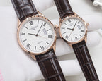 Two white dial quartz watches with Roman numerals, rose gold cases, black leather straps