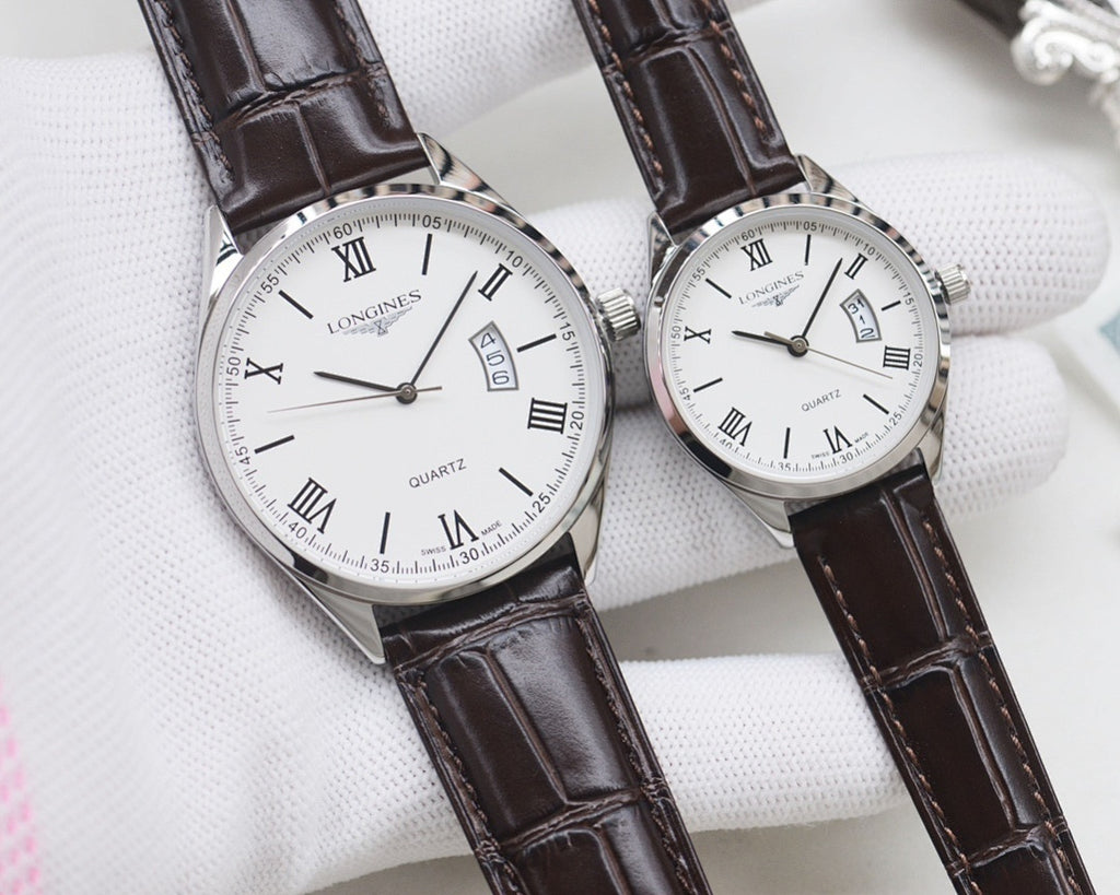 Two white dial quartz watches with Roman numerals, silver cases, black leather straps