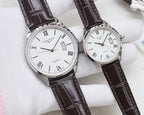 Two white dial quartz watches with Roman numerals, silver cases, black leather straps