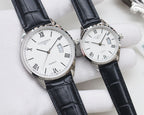 Two quartz watches: black and white dials, silver cases, black leather straps