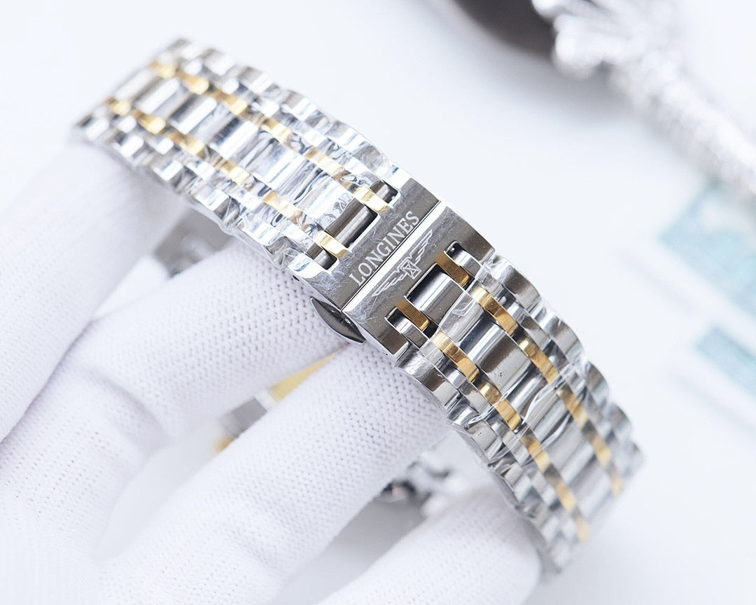 Two-tone Longines watch bracelet with silver links and gold-accent center bars.
