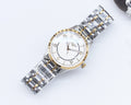 Two-tone Longines watch with silver bracelet, white dial, gold bezel accents and hands.