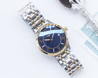 Two-tone Longines watch with blue dial, gold bezel, and silver-and-gold link bracelet.