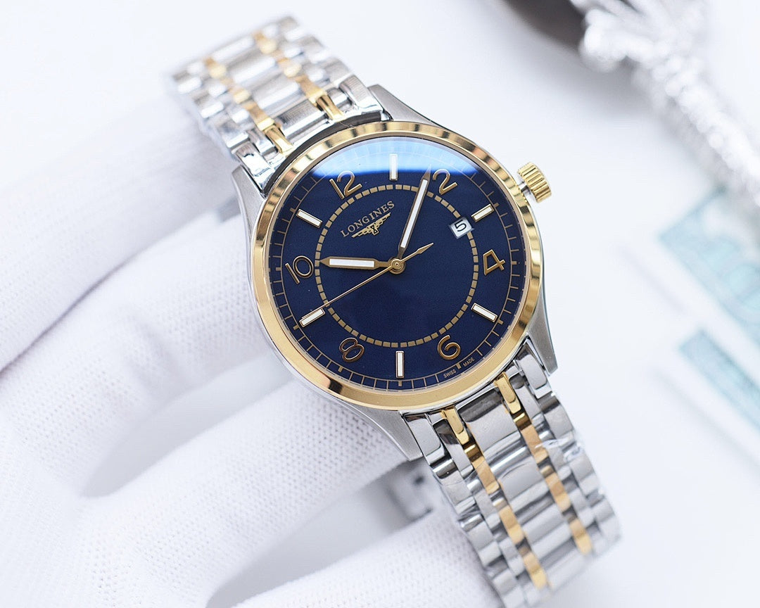 Two-tone Longines watch with blue dial, gold bezel, and silver-and-gold link bracelet.