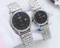 Pair of quartz wristwatches with black dials and silver metal bracelet straps