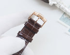 Brown leather watch strap with gold-tone buckle and clasp hardware