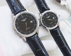 Pair of quartz wristwatches with dark dials and dark leather strap