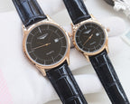 Pair of quartz wristwatches with black dials and black leather straps
