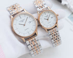 Pair of quartz wristwatches with white dials and rose-gold metal bracelet straps