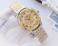 Two-tone stainless steel watch, gold dial with day-date window