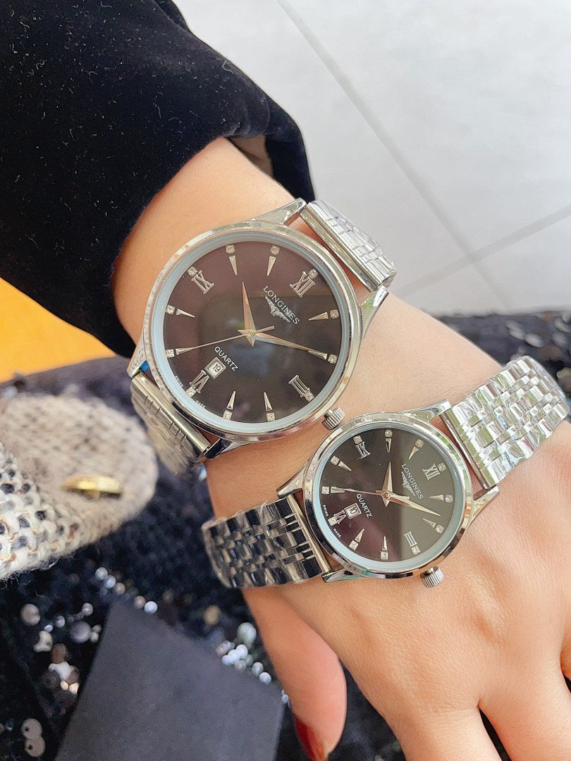 Longines watches on wrists with silver metal bands and dark brown round dials