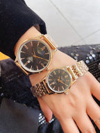 Longines watches on wrists with gold-tone bands and dark brown round dials