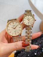 Longines watch pair with gold-tone metal bracelets and cream round dials
